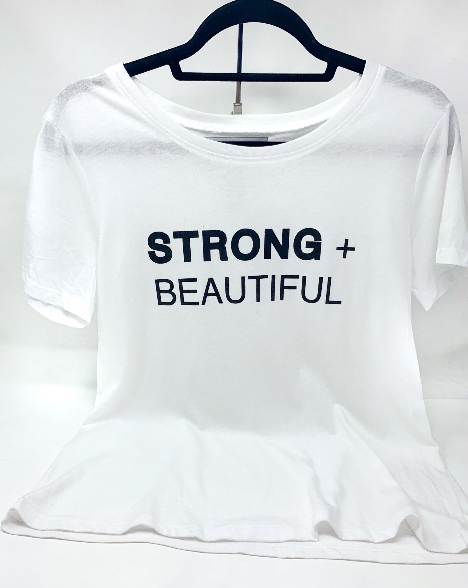 Strong + Beautiful white short sleeve t-shirt on hanger